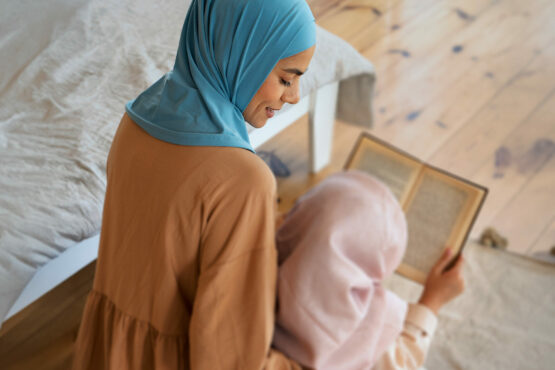 Mother daughter reciting Quran