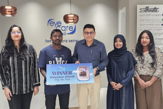 Mohamed Saufan receiving Ramadan Umrah Trip for Two prize at EyeCare Optical outlet
